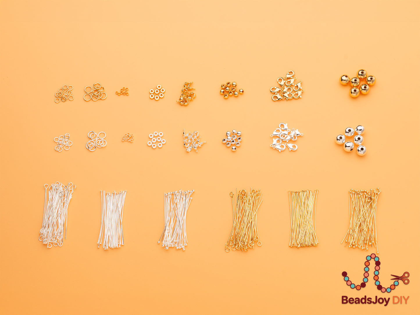 Assorted gold and silver jewelry findings flat lay including jump rings, crimp beads, spacer beads, lobster clasps, round beads, ball pins, eye pins and T-pins for DIY jewelry making