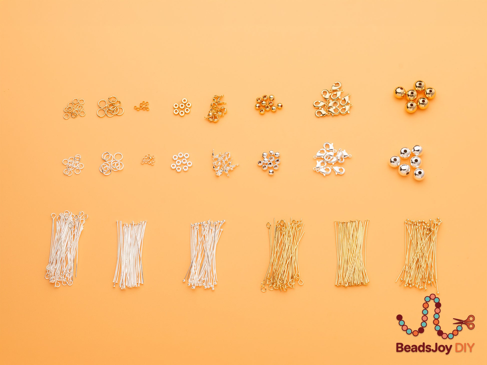 Assorted gold and silver jewelry findings flat lay including jump rings, crimp beads, spacer beads, lobster clasps, round beads, ball pins, eye pins and T-pins for DIY jewelry making